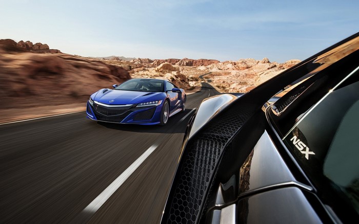 Blue Acura NSX and black car on desert road