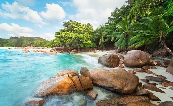 Tropical beach with turquoise water and granite boulders