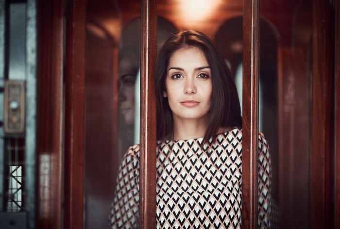 Woman with long brown hair in a patterned top