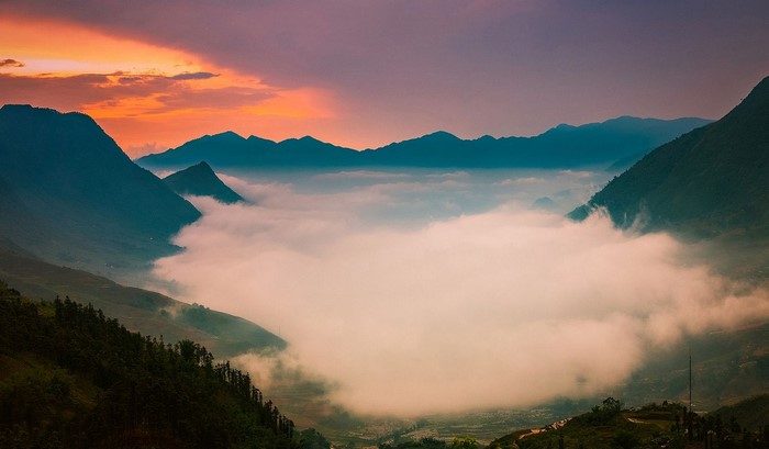 Mountains shrouded in mist at sunset