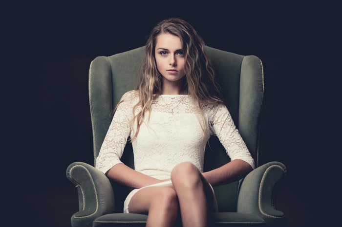 Woman with long blonde hair sitting in a chair