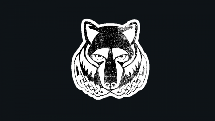 Monochrome illustration of a wolf head with tribal markings