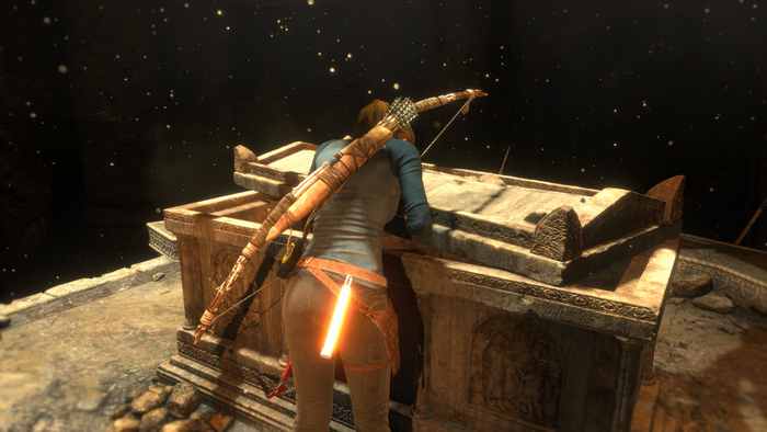 Lara Croft from Rise of the Tomb Raider on a tomb