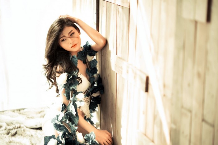 Asian woman with long hair adorned with leaves