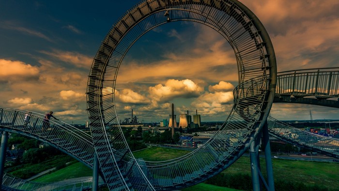 Roller coaster structure with power plant in background