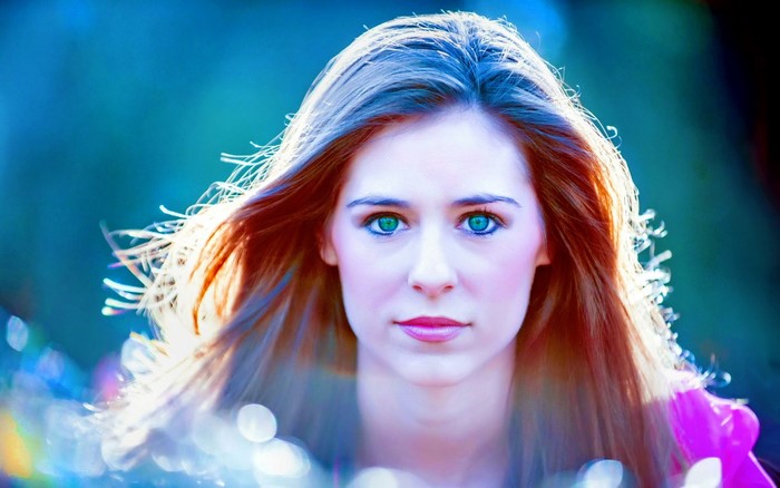 Woman with long red hair and green eyes