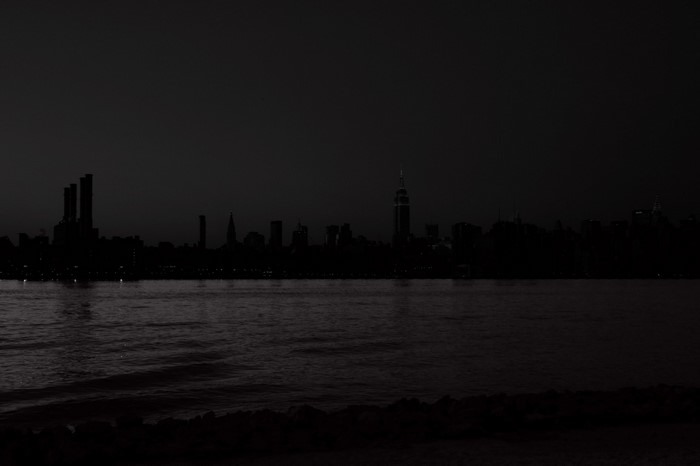New York City skyline at night over water