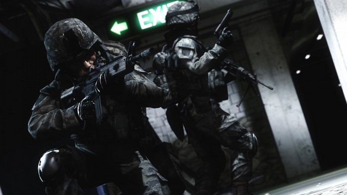 Soldiers in a dark corridor with an exit sign