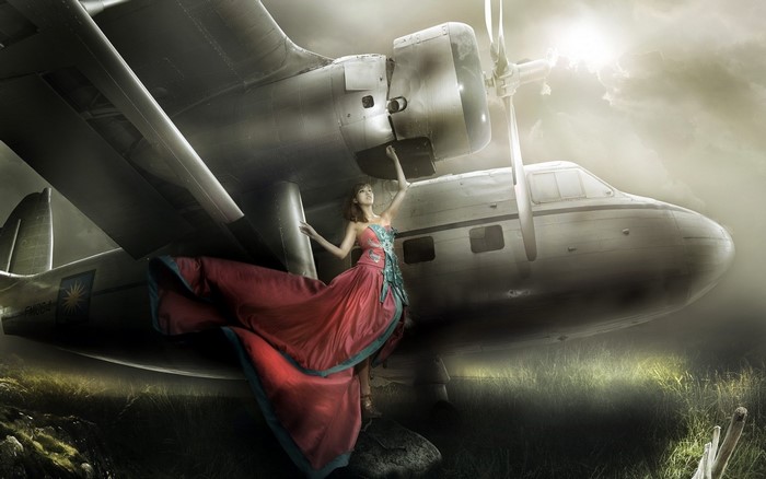 Woman in red dress near airplane