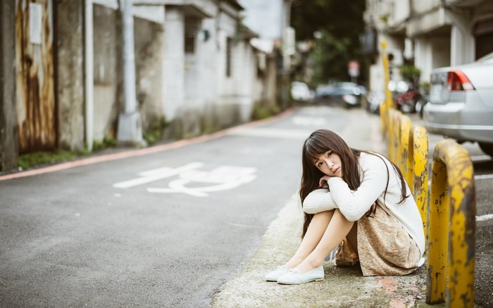 Woman sitting on a street