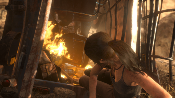 Lara Croft from Tomb Raider in a burning vehicle