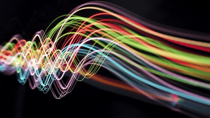 Abstract colorful light trails on black background