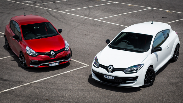 Two Renault hot hatch cars parked on asphalt