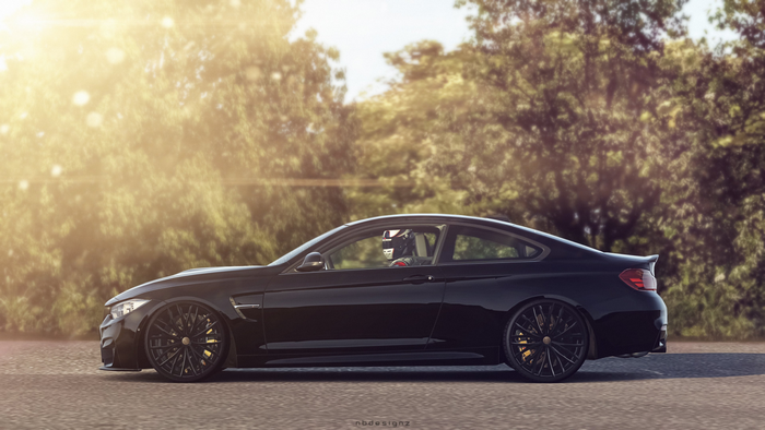 Black BMW M4 Coupe on Road with Trees