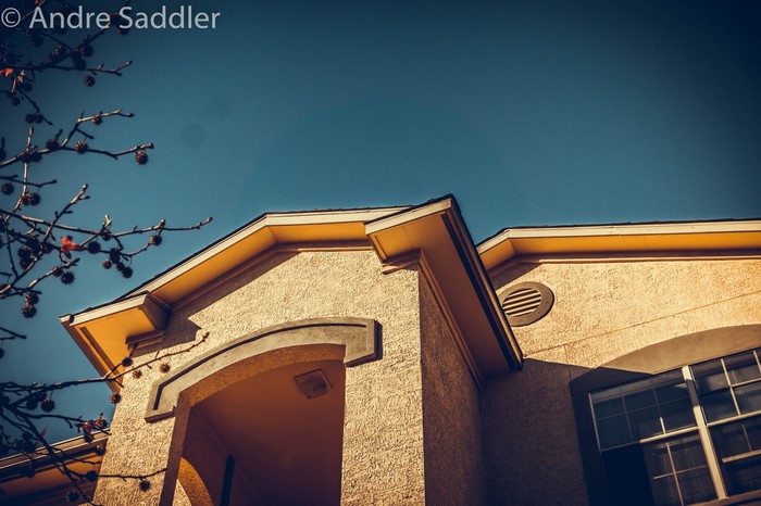 Building Facade with Yellow Trim and Blue Sky