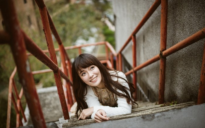 Smiling Woman Lying on Outdoor Stairs