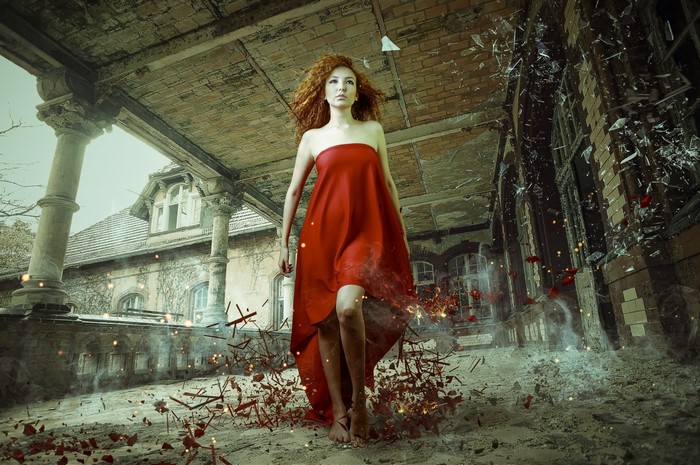 Woman in red dress in ruined building