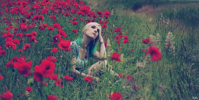 Woman with Dyed Hair Sitting in Red Poppy Field
