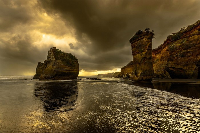Dramatic coastal landscape with rock formations and stormy sky