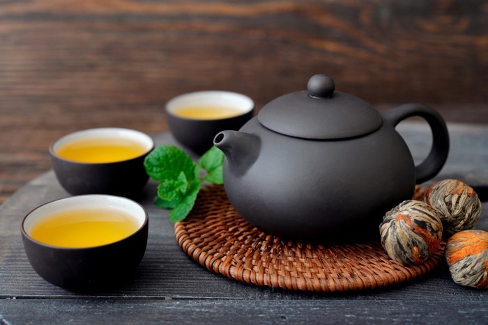 Elegant Black Teapot with Cups and Tea Balls