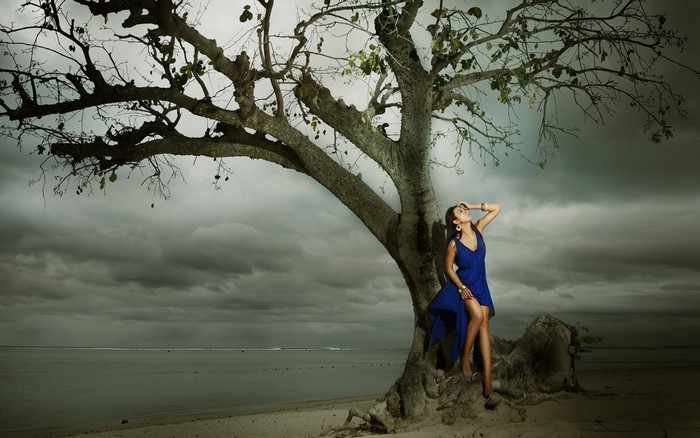 Woman in Blue Dress by Tree on Beach