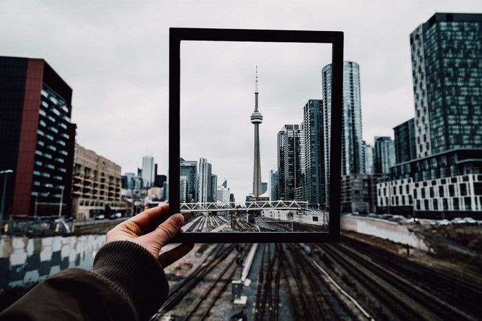 Toronto cityscape with CN Tower framed by hand