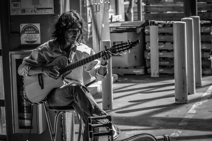 Man playing guitar on a street