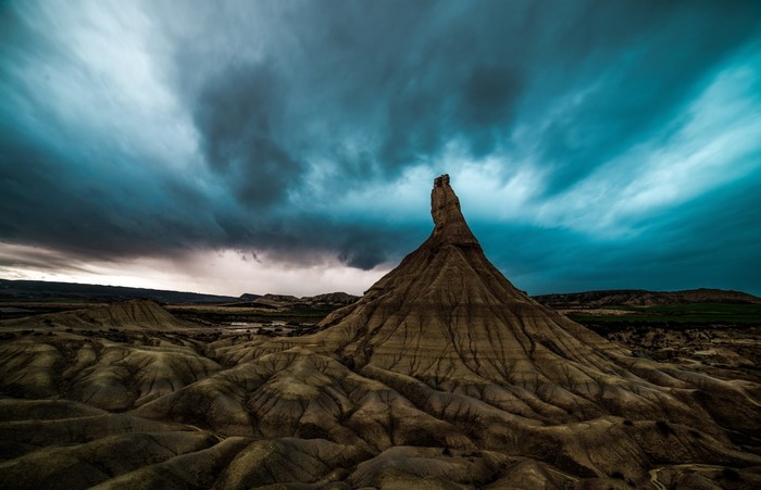 Badlands landscape with dramatic stormy sky
