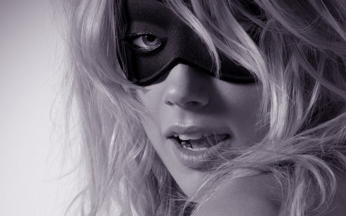 Woman wearing a black mask, close-up portrait