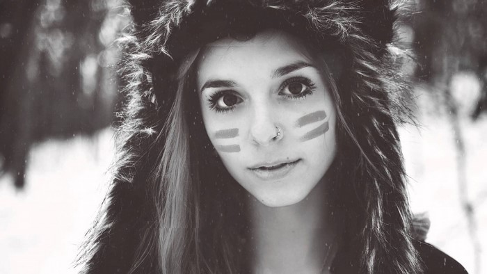 Woman with face paint and fur hood in winter