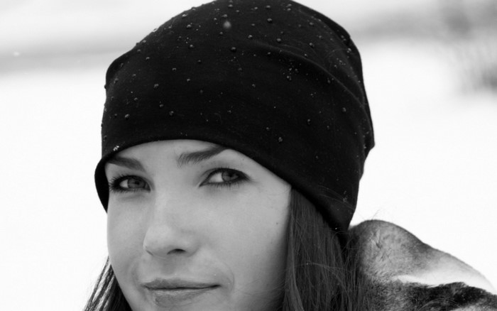 Woman wearing a black beanie in the snow