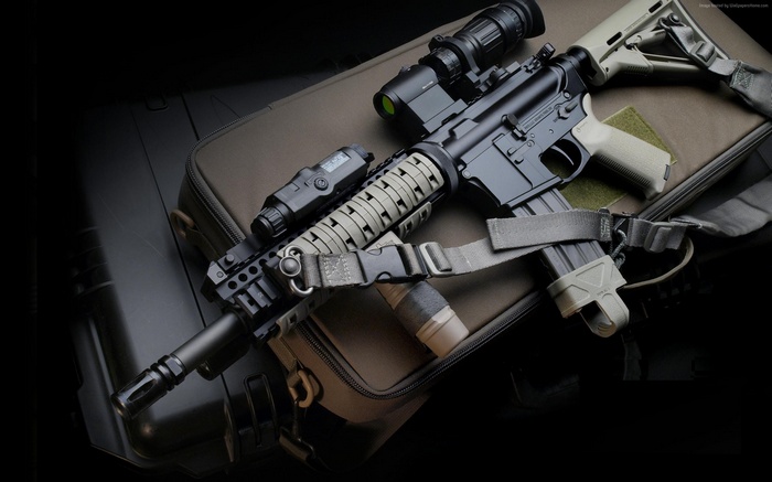 AR-15 style rifle with accessories on a bag
