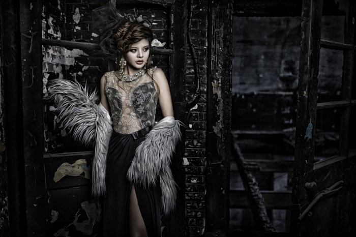 Asian woman in gothic fashion in a dark, ruined setting