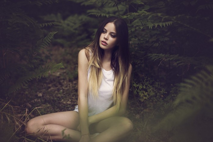 Contemplative Woman Sitting in Forest