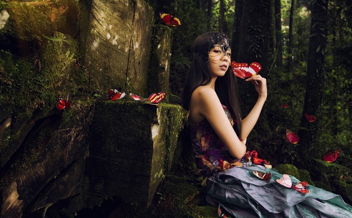 Woman in a fantasy forest with butterflies