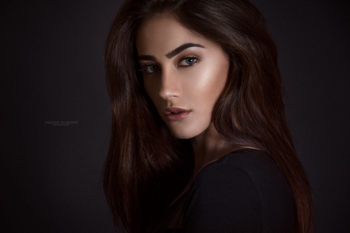 Woman with long brown hair and blue eyes