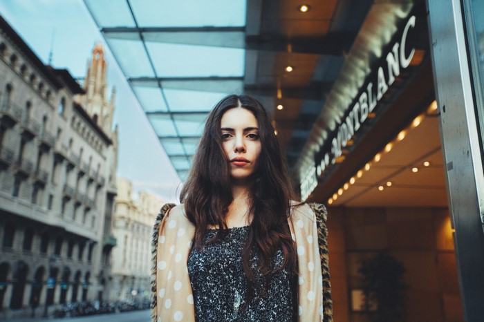 Woman in polka dot jacket in front of Montblanc store