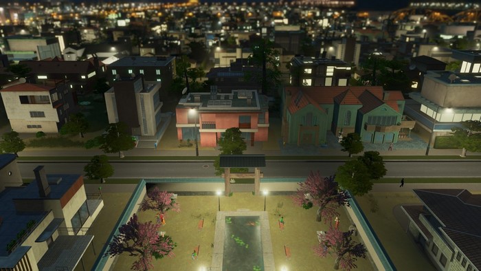 Cityscape at night with residential buildings and a park