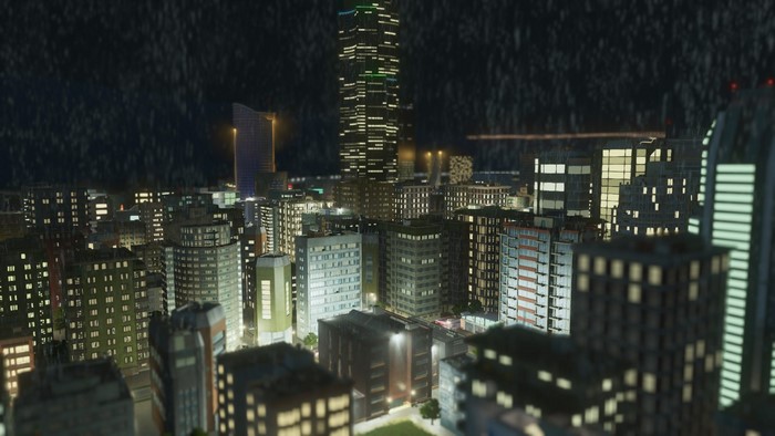 Cityscape at night with skyscrapers and lights