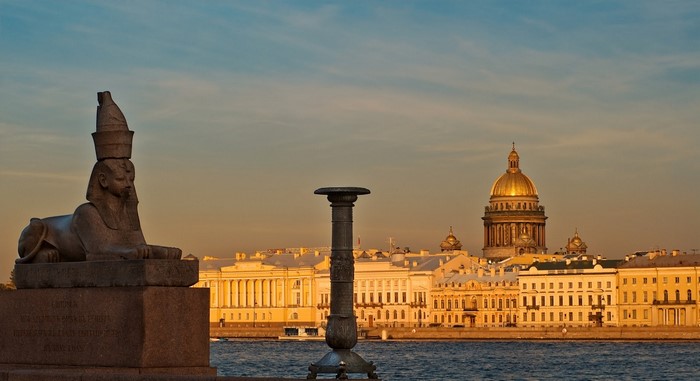 Sphinx sculpture and St. Isaac's Cathedral in St. Petersburg at sunset