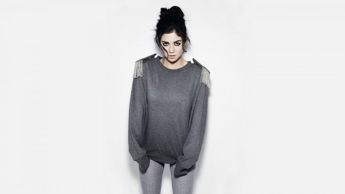 Marina Diamandis wearing a grey sweater with fringe