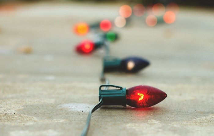 Close-up of red Christmas lights on a concrete surface