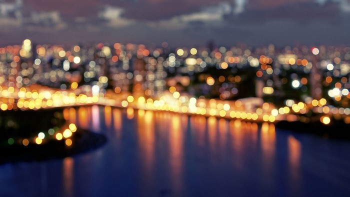 City lights reflecting on water at night