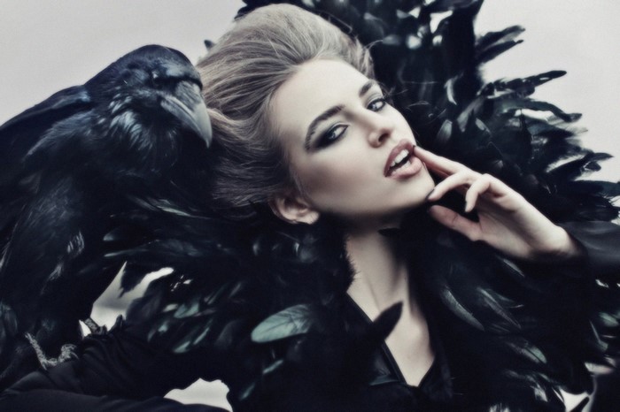Woman with black feathers and a raven