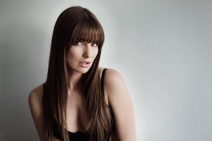 Woman with long brown hair and bangs