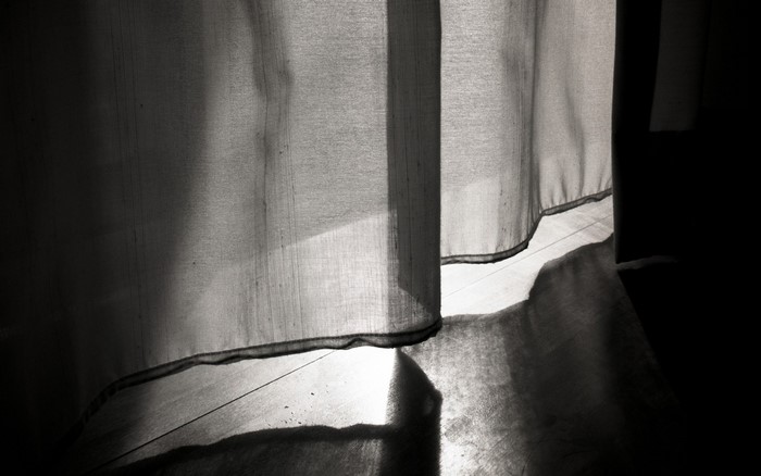 Monochrome photography of light and shadow on curtains
