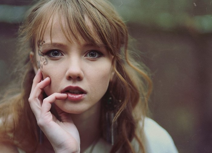 Portrait of a Redhead Woman with Blue Eyes and Facial Tattoo