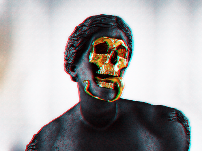 Gold skull mask on a statue with a snake tongue