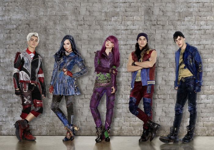 Descendants 2 characters standing against a brick wall