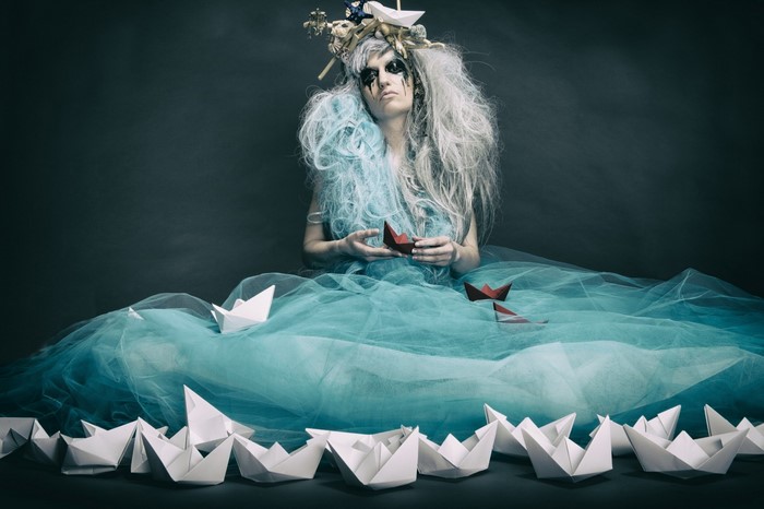 Woman with paper boats and elaborate headdress